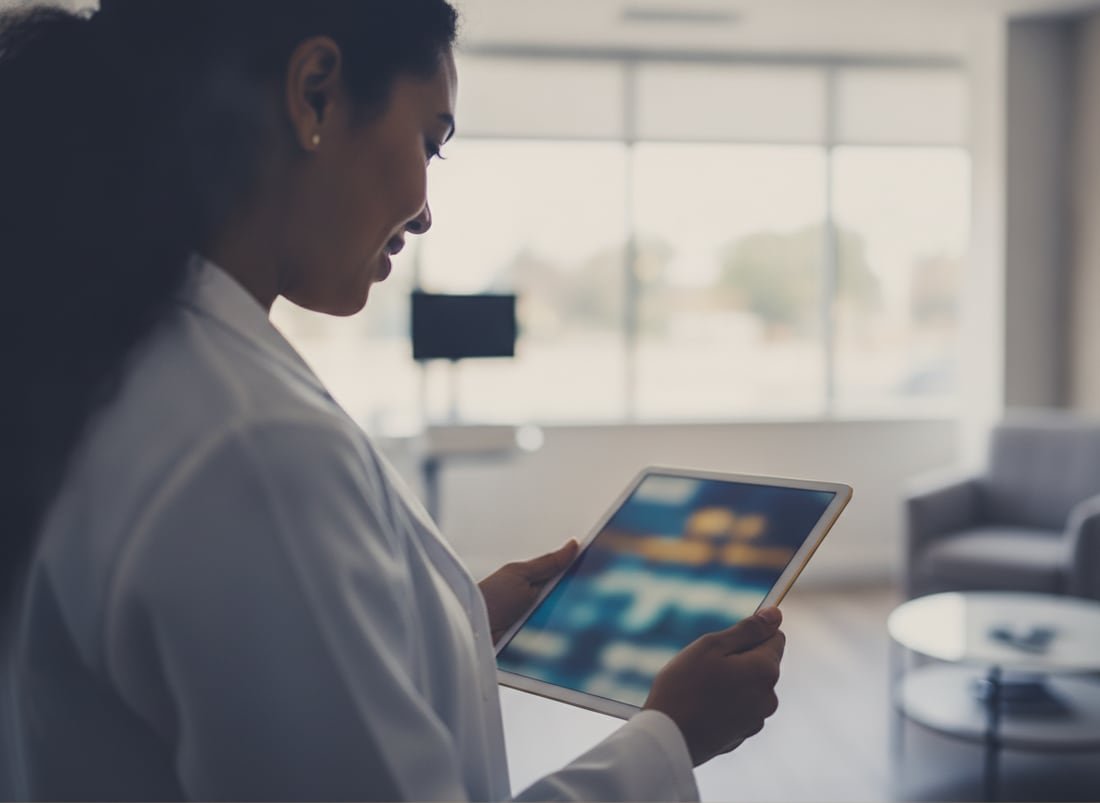 A BridgeCare Louisiana clinician reviewing a patient's remote-monitoring vital signs on a tablet